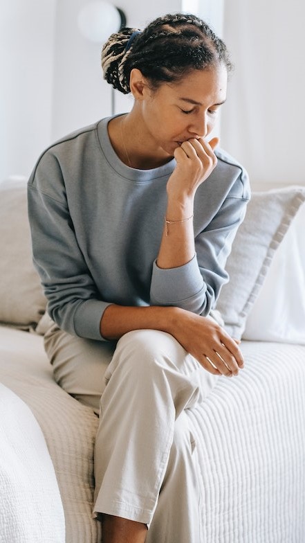 Person sitting on bed